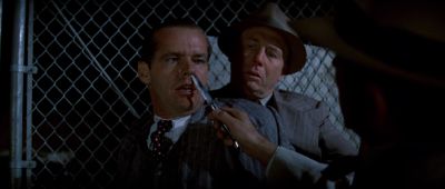 Still from Chinatown (1974) that has been tagged with: over-the-shoulder & chainlink fence