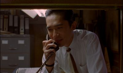 Still from In the Mood For Love (2000) that has been tagged with: phone & fluorescent light