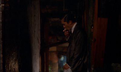 Still from In the Mood For Love (2000) that has been tagged with: medium wide & dark alley