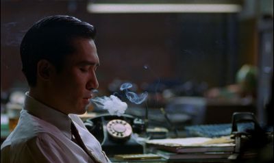 Still from In the Mood For Love (2000) that has been tagged with: fluorescent light & smoking