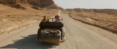 Still from Indiana Jones and the Raiders of the Lost Ark (1981) that has been tagged with: looking back & dirt road