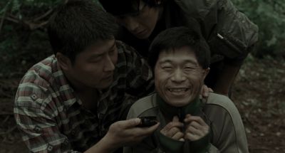 Still from Memories of Murder (2003) that has been tagged with: three-shot & laughing
