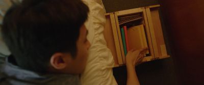 Still from Parasite (2019) that has been tagged with: laying down & bed & book