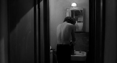 Still from Rumble Fish (1983) that has been tagged with: over-the-shoulder & bathroom