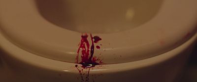 Still from Swallow (2019) that has been tagged with: extreme close-up & toilet