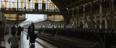 Still from Tár (2022) that has been tagged with: train station & over-the-shoulder