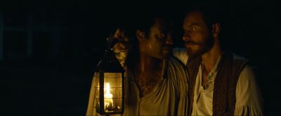 Still from 12 Years a Slave (2013) that has been tagged with: 2b1508 & medium shot & exterior & night & candlelight