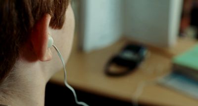 Still from A Serious Man (2009) that has been tagged with: extreme close-up & earphones