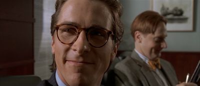 Still from American Psycho (2000) that has been tagged with: conference room & two-shot & close-up & glasses