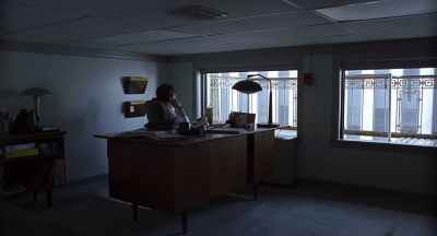 Still from Being John Malkovich (1999) that has been tagged with: wide shot & day & desk