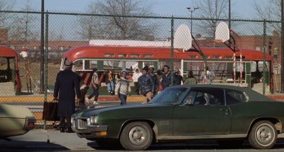 Still from Being There (1979) that has been tagged with: exterior & chainlink fence & car