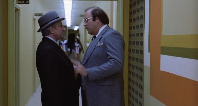 Still from Being There (1979) that has been tagged with: profile shot & two-shot & hallway & medium shot