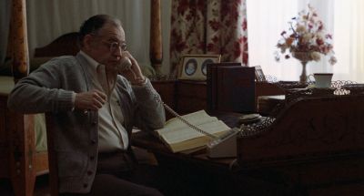 Still from Being There (1979) that has been tagged with: day & profile shot & reading & desk