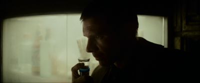 Still from Blade Runner (1982) that has been tagged with: interior & medium close-up & clean single & smelling