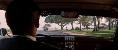 Still from Chinatown (1974) that has been tagged with: interior & medium close-up & over-the-shoulder & car interior & car