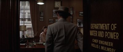 Still from Chinatown (1974) that has been tagged with: cfcfc4 & doorway & practical lamp & secretary