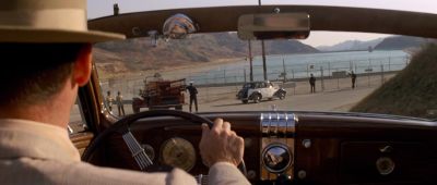 Still from Chinatown (1974) that has been tagged with: interior & medium close-up & rearview mirror & convertable & reservoir & over-the-shoulder