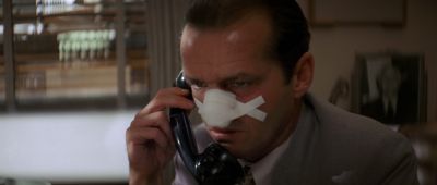 Still from Chinatown (1974) that has been tagged with: medium close-up & phone & day & clean single