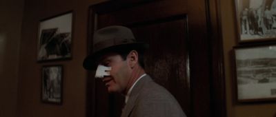 Still from Chinatown (1974) that has been tagged with: interior & medium close-up & day & clean single & profile shot & low-angle