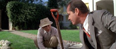 Still from Chinatown (1974) that has been tagged with: gardening & exterior & garden & two-shot & shovel