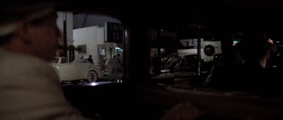 Still from Chinatown (1974) that has been tagged with: night & backseat & medium shot & car interior