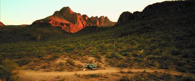 Still from Confessions of a Dangerous Mind (2002) that has been tagged with: car & mountains & golden hour & exterior & establishing shot