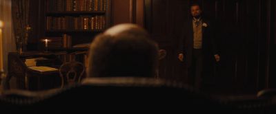 Still from Django Unchained (2012) that has been tagged with: b98927 & night & over-the-shoulder & interior