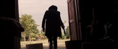 Still from Django Unchained (2012) that has been tagged with: medium wide & backlit & knife & silhouette & doorway & over-the-shoulder