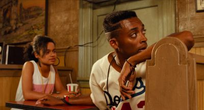 Still from Do the Right Thing (1989) that has been tagged with: pizza & table & interior