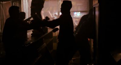 Still from Do the Right Thing (1989) that has been tagged with: medium wide & interior & group-shot & looting