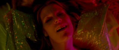 Still from Enter The Void (2009) that has been tagged with: 7a3f00 & night & interior & close-up