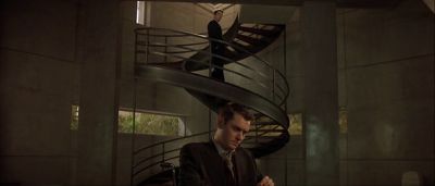 Still from Gattaca (1997) that has been tagged with: over-the-shoulder & spiral stairs