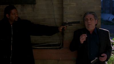 Still from Ghost Dog: The Way of the Samurai (1999) that has been tagged with: gun & medium wide & brick wall