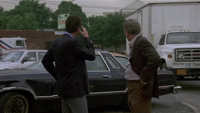 Still from GoodFellas (1990) that has been tagged with: two-shot & parking lot & day