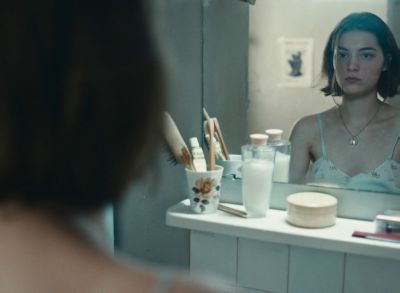 Still from Happening (2021) that has been tagged with: reflection & over-the-shoulder & interior & bathroom
