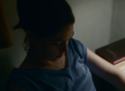 Still from Happening (2021) that has been tagged with: interior & night & medium close-up & high-angle