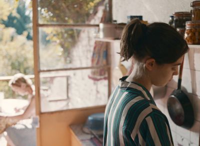 Still from Happening (2021) that has been tagged with: kitchen & profile shot