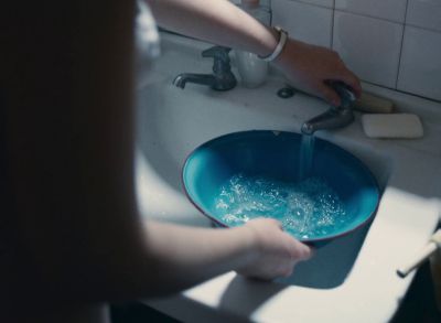 Still from Happening (2021) that has been tagged with: interior & high-angle & sink & bathroom