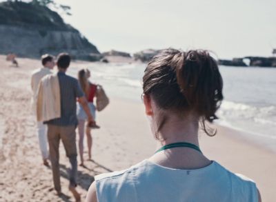 Still from Happening (2021) that has been tagged with: beach & over-the-shoulder