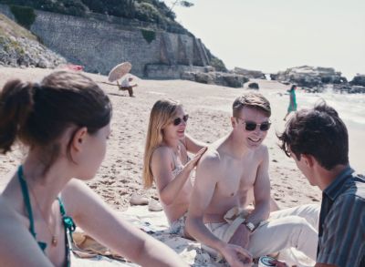 Still from Happening (2021) that has been tagged with: day & exterior & group-shot & beach