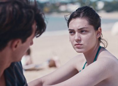 Still from Happening (2021) that has been tagged with: exterior & day & two-shot & beach