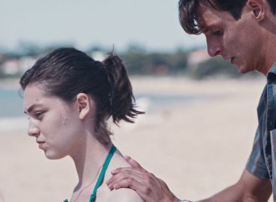 Still from Happening (2021) that has been tagged with: two-shot & day & medium close-up & beach