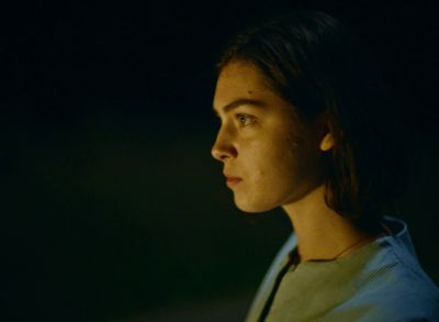 Still from Happening (2021) that has been tagged with: exterior & night & profile shot & clean single
