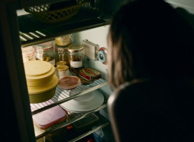 Still from Happening (2021) that has been tagged with: over-the-shoulder & refrigerator & interior