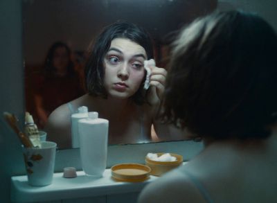 Still from Happening (2021) that has been tagged with: reflection & mirror & medium shot
