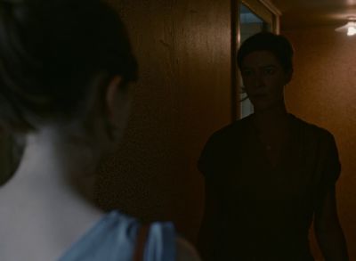 Still from Happening (2021) that has been tagged with: 2b1508 & night & over-the-shoulder & hallway
