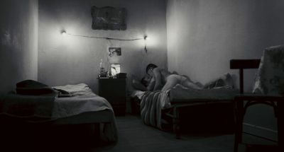Still from Happy Together (1997) that has been tagged with: bed & black and white & bedroom & sex & two-shot