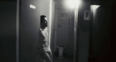 Still from Happy Together (1997) that has been tagged with: black and white & bathroom & toilet & night & medium wide