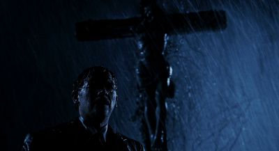 Still from Hellboy (2004) that has been tagged with: clean single & crucifix & low-angle & rain & cross & night