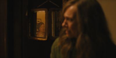 Still from Hereditary (2018) that has been tagged with: interior & profile shot & night & over-the-shoulder